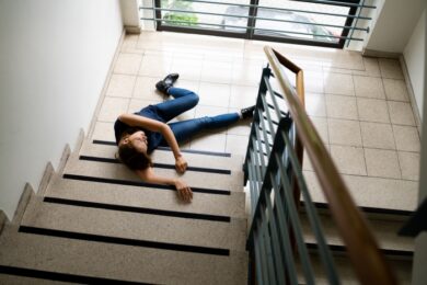 Slip And Fall Accident On Stairs. Worker Woman Fallen Down